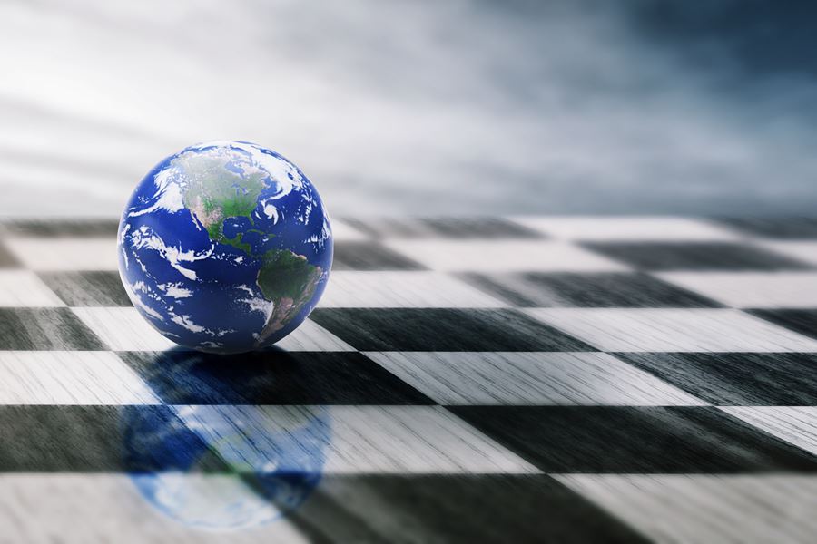 small globe on a black and white chess board