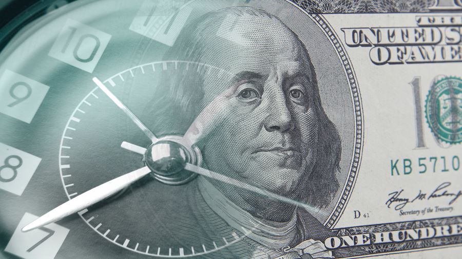 analog clock over a 100 dollar bill